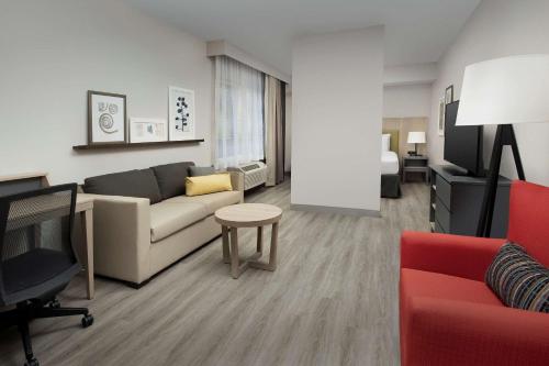 a living room with a couch and a table at Country Inn & Suites by Radisson, Seattle-Tacoma International Airport, WA in SeaTac