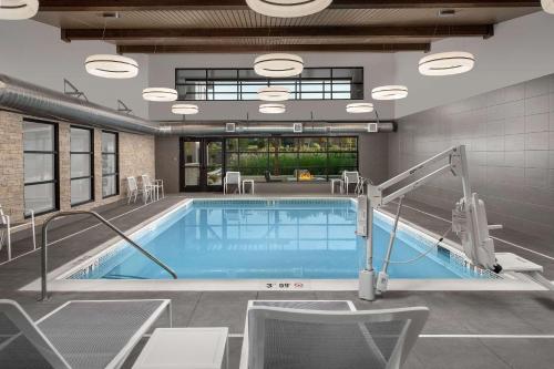 a pool in a building with a swimming pool at Country Inn & Suites by Radisson, Seattle-Tacoma International Airport, WA in SeaTac