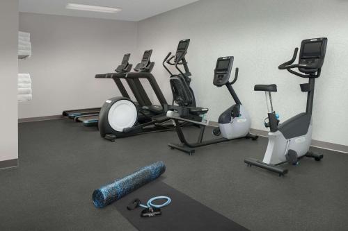 a gym with several exercise equipment in a room at Country Inn & Suites by Radisson, Seattle-Tacoma International Airport, WA in SeaTac