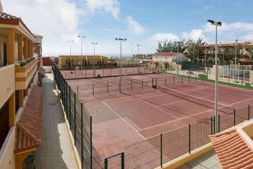 a tennis court with two tennis courts at Elba Lucía Sport & Suite Hotel in Costa de Antigua
