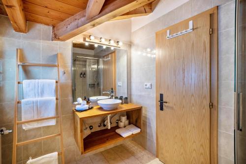 a bathroom with a sink and a mirror at Mountain Residence Kasern Nr 5 in Predoi