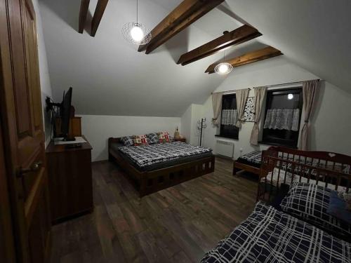 a large living room with a bed and a couch at Chalupa pod hradom Branč in Podbranč