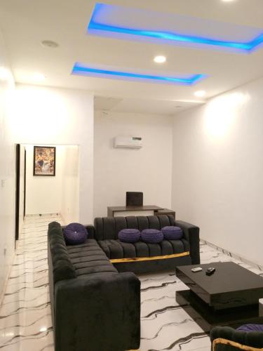 a living room with a couch and a blue ceiling at Inviting 2-Bed Apartment in Ifako-Ijaiye in Lagos