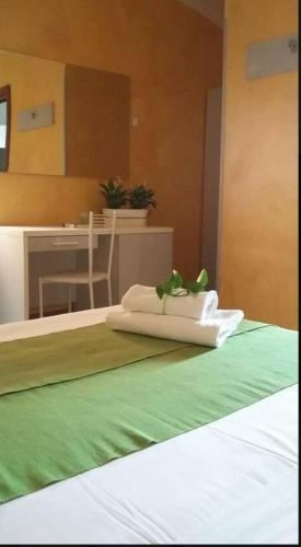 a bed with a white pillow with a plant on it at Sabrina Airport in Fiumicino