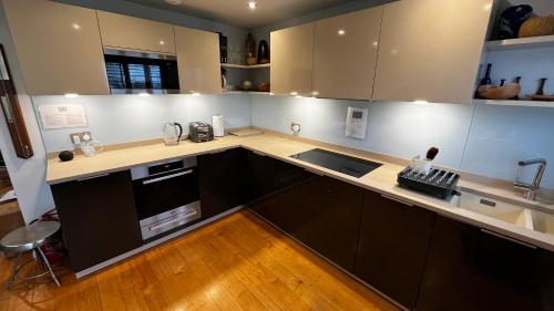 a kitchen with a sink and a counter top at Modern Seaside Townhouse feat Sauna near Brighton in Shoreham-by-Sea