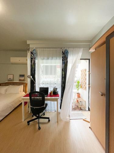 a bedroom with a desk and a bed and a chair at Tower Resident in the Heart of Bangkok Shopping Center in Makkasan