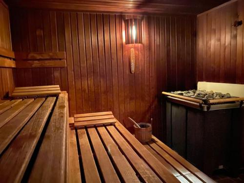 a wooden room with two empty benches in it at Skyline Appartement mit Pool and Netflix in Kronberg im Taunus