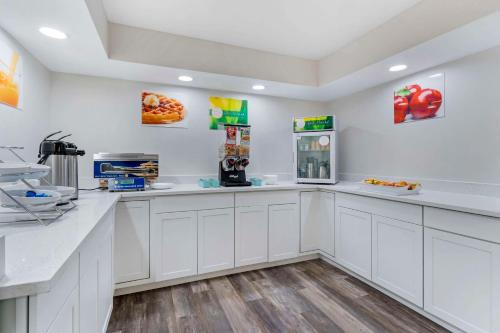 a large white kitchen with white counter tops at Quality Inn & Suites Orlando East - UCF Area in Orlando
