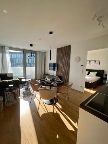 a living room with a table and a couch at The View 1 in Vienna