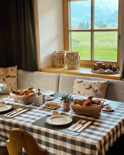 a table with a checkered table cloth with food on it at Haus Tirol Ehrwald in Ehrwald