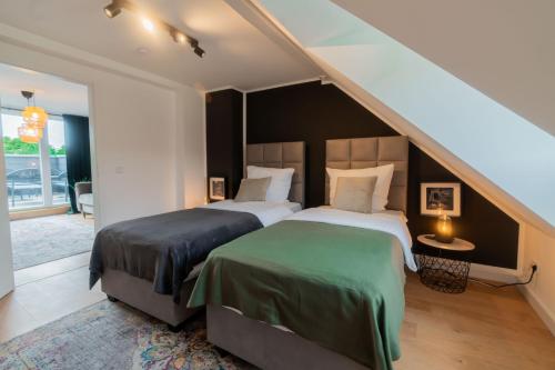 a bedroom with two beds and a staircase at Rooftop Suite Essen Central-Fair-HBF-Uniklinik-Balcony-Walk-In Shower-Coffee station-WiFi-Workspace in Essen