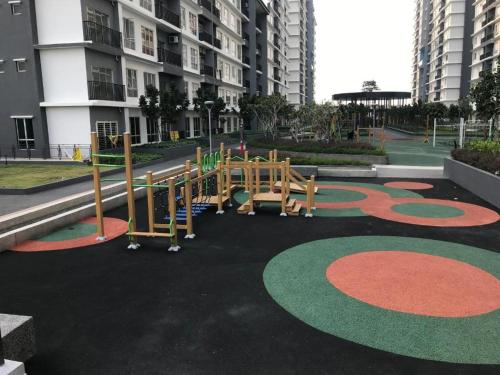 a playground in a park in front of a building at BSP21 Homestay in Jenjarum
