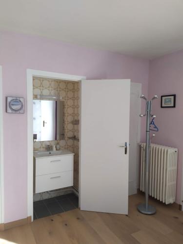 a bathroom with a sink and a mirror at Entre mer et bocage in Coutances