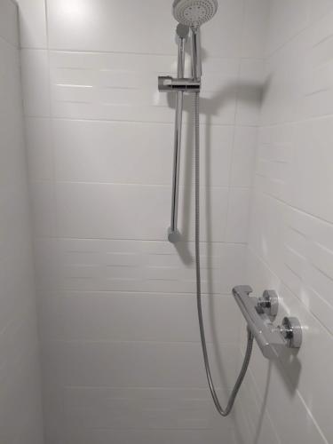 a shower with a shower head in a bathroom at Entre mer et bocage in Coutances