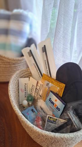 a basket filled with medicines and other items on a table at Silk Cotton Cottages in Parrot Hall
