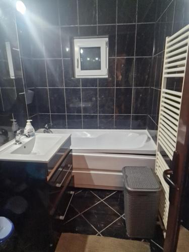 a bathroom with a bath tub and a sink at 2 bedrooms Apartment. in Galaţi