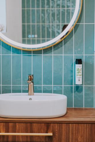 a white sink in a bathroom with a mirror at Resort Český les in Bělá nad Radbuzou