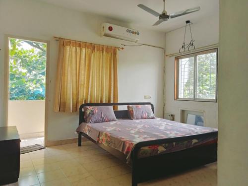 a bedroom with a bed in a room with a window at happystay@casablanca2 in Chennai