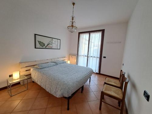 a bedroom with a bed and a table and a chair at Casa di Gabry in Cento