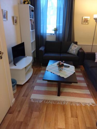 a living room with a couch and a coffee table at Hotell Hemgården in Bengtsfors