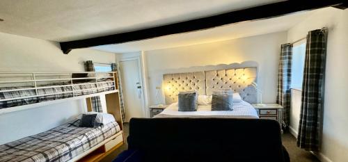 - une chambre avec 2 lits superposés et un canapé dans l'établissement Saughy rigg farm, à Haltwhistle