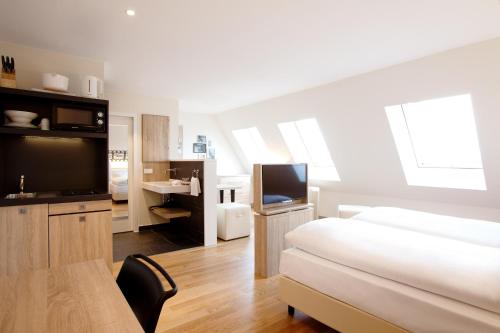 a bedroom with a bed and a flat screen tv at Vienna House Easy by Wyndham München in Munich