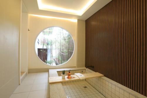 a bathroom with a sink and a round window at Yeonriji in Gyeongju