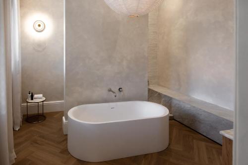 a white bath tub in a bathroom with a shower at NOAH House in Cape Town