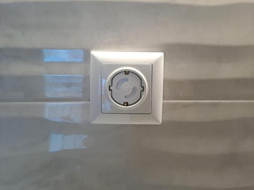 a white electrical outlet on a white wall at ParkView Central Apartment - Xanthi in Xanthi