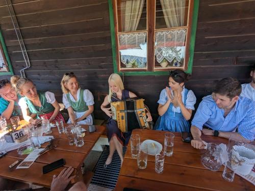 a group of people sitting at tables in a restaurant at Ferienwohnung Ottmanach Schlosshof in Pischeldorf