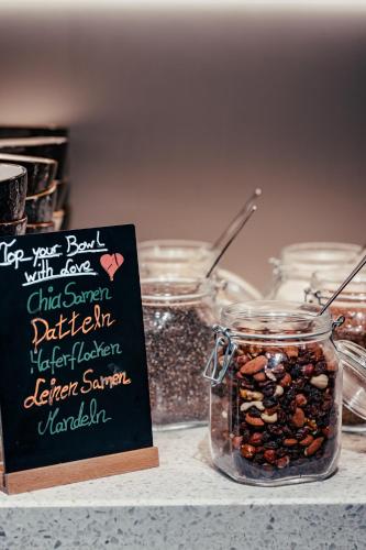a mason jar filled with nuts and a sign on a counter at URBAN LOFT Cologne in Cologne