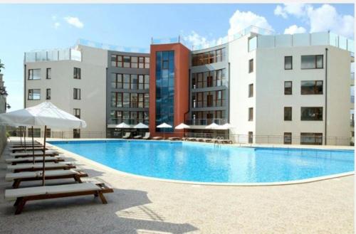 a swimming pool in front of a building at Sun Wave Sea and Pool View in Sveti Vlas