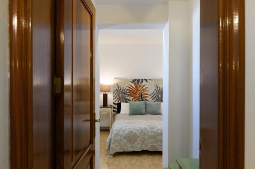 a bedroom with a bed with blue pillows at Villa Golf Lanzarote in Costa Teguise
