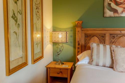 a bedroom with a bed and a lamp on a table at Yellowrush Lodge @ Yellowtop in Selby