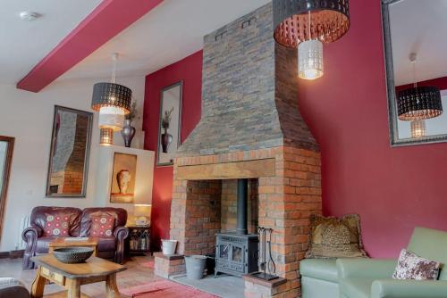 a living room with a brick fireplace at Yellowrush Lodge @ Yellowtop in Selby