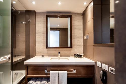 a bathroom with a sink and a mirror at Queen of Sheba Eilat in Eilat
