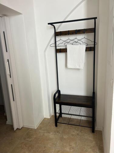 a black shelf in a room with a towel at Apartment in Stadtzentrum Oelsnitz in Oelsnitz