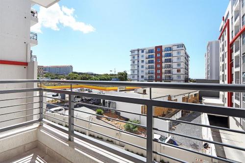 a balcony with a view of a street and buildings at The Paragon 317 by HostAgents in Cape Town