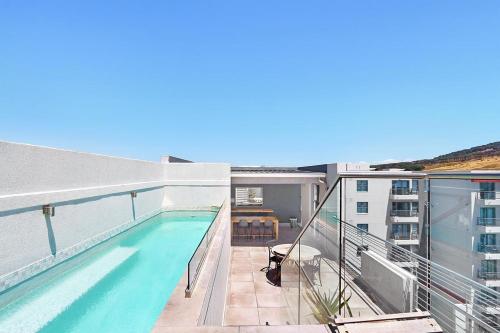 a balcony with a swimming pool on a building at The Paragon 317 by HostAgents in Cape Town