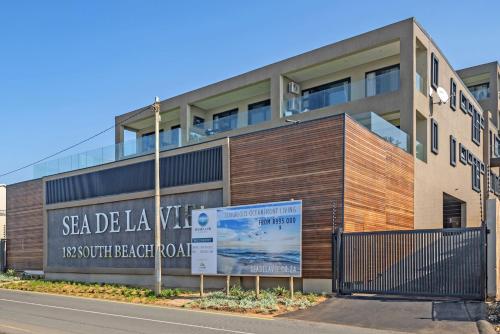 a building with a sign in front of it at Sea De La Vie 25 by HostAgents in La Mercy