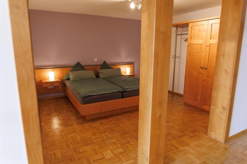 a bedroom with a bed with two lights on it at Appartements im Weingut Frieden-Berg in Nittel