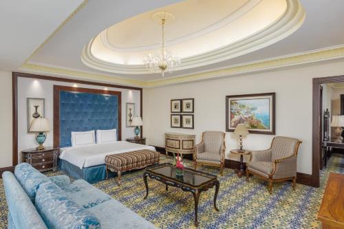 a hotel room with a bed and a couch at Swissotel Makkah in Makkah