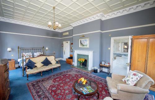 a living room with a couch and a fireplace at The Central Hotel in Scarborough