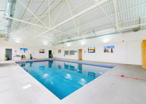 a large swimming pool in a building at Viewfield Manor Leisure Park in Springside