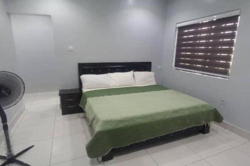 a bedroom with a bed and a window in it at Luxe Living:4Bed, TV, Pool& WiFi in Lekki