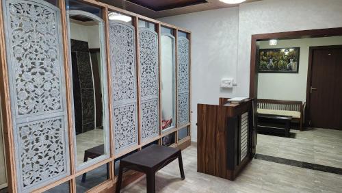 a room with a wooden partition with a chair and a table at NANDI RETREAT HomeStay in Varanasi