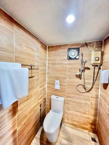a bathroom with a toilet and a shower at Lay Back Villa Wooden House AC Hot shower High Speed Internet in Krabi town