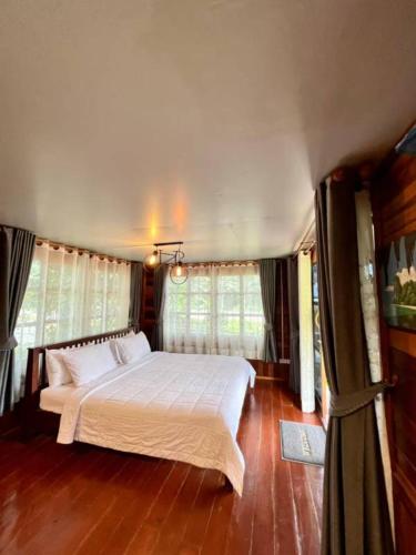 a bedroom with a large bed in a room at Lay Back Villa Wooden House AC Hot shower High Speed Internet in Krabi town