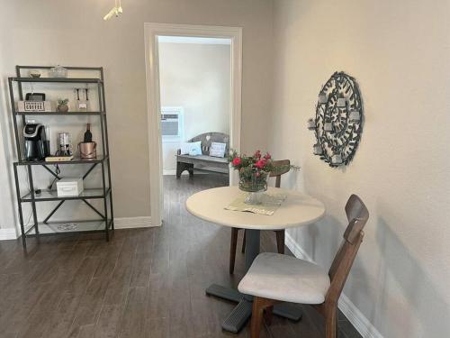 a room with a table with a vase of flowers on it at Quiet, Cozy Guesthouse with privacy in Manvel