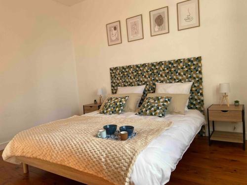 a bedroom with a large bed with a tray on it at Casa Cosy in Angers